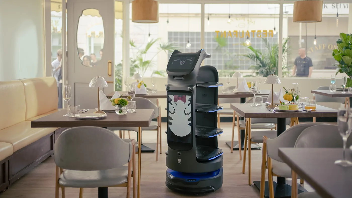 A service robot delivering to tables in a cafe